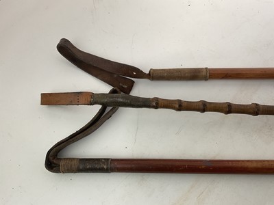 Lot 964 - Three antique hunting whips with white metal collars and bamboo shafts with antler handles