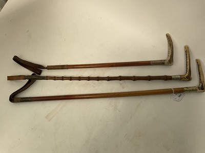 Lot 964 - Three antique hunting whips with white metal collars and bamboo shafts with antler handles