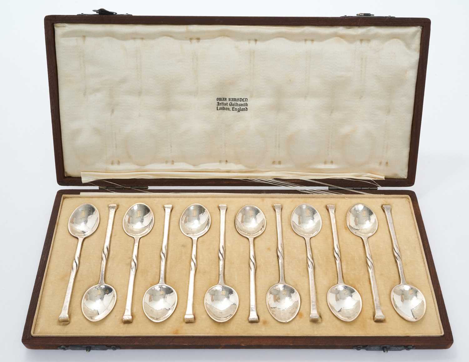Lot 297 - Cased set of twelve teaspoons by Omar Ramsden