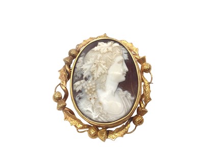 Lot 207 - 19th century carved shell cameo brooch depicting a bacchanalian classical female bust with grape vines in her hair and a glazed compartment to the reverse, in a revolving oval gold brooch mount...