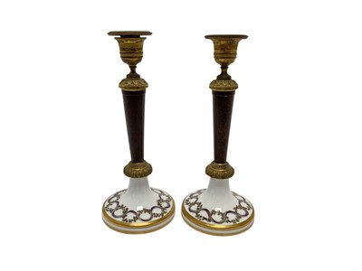 Lot 103 - Formerly the gift of Napoleon Bonaparte, Pair Early 19th century French Paris porcelain, simulated porphyry and ormolu mounted candlesticks
