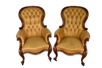 Lot 1322 - Pair of Victorian button leather upholstered armchairs, each with spoon shaped back and showwood frame on castors