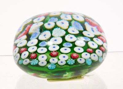 Lot 222 - 19th century French millefiori glass paperweight, with various coloured canes on a green ground