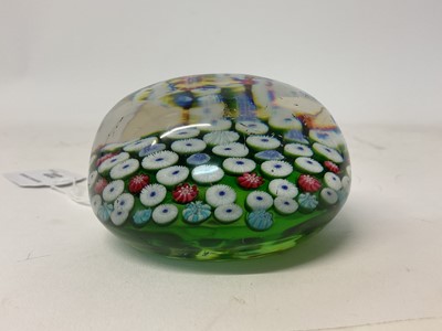 Lot 222 - 19th century French millefiori glass paperweight, with various coloured canes on a green ground