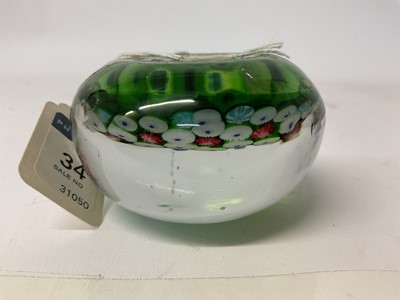 Lot 222 - 19th century French millefiori glass paperweight, with various coloured canes on a green ground