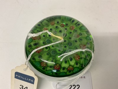 Lot 222 - 19th century French millefiori glass paperweight, with various coloured canes on a green ground