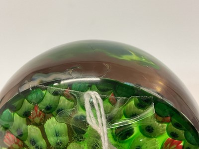 Lot 222 - 19th century French millefiori glass paperweight, with various coloured canes on a green ground