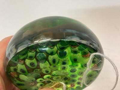 Lot 222 - 19th century French millefiori glass paperweight, with various coloured canes on a green ground