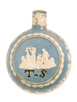 Lot 207 - Unusual 19th century pottery flask, decorated in relief with figural scenes and flowers, inscribed with the initials 'TS', on a blue-glazed ground, 17.5cm high