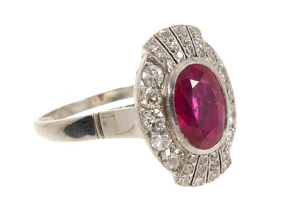 Lot 624 - Art Deco style ruby and diamond cluster cocktail ring with an oval mixed cut ruby estimated to weigh approximately 3.25cts, surrounded by ten brilliant cut diamonds estimated to weigh approximat...