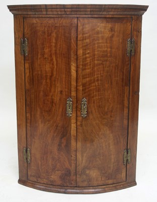 Lot 1719 - George I walnut bowfront corner cupboard