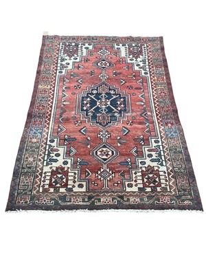 Lot 1502 - Eastern rug with geometric decoration on red, blue and cream ground, 188cm x 122cm