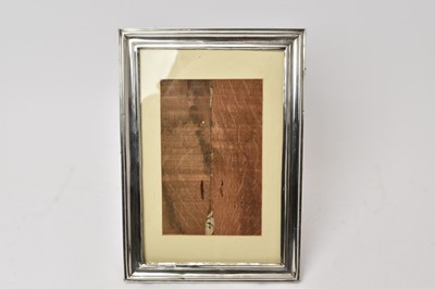 Lot 535 - Large George V silver photograph frame of rectangular form with reeded decoration, oak backing and easel support, (Birmingham 1922), maker Hasset & Harper Ltd, 30.5 x 21.5cm.