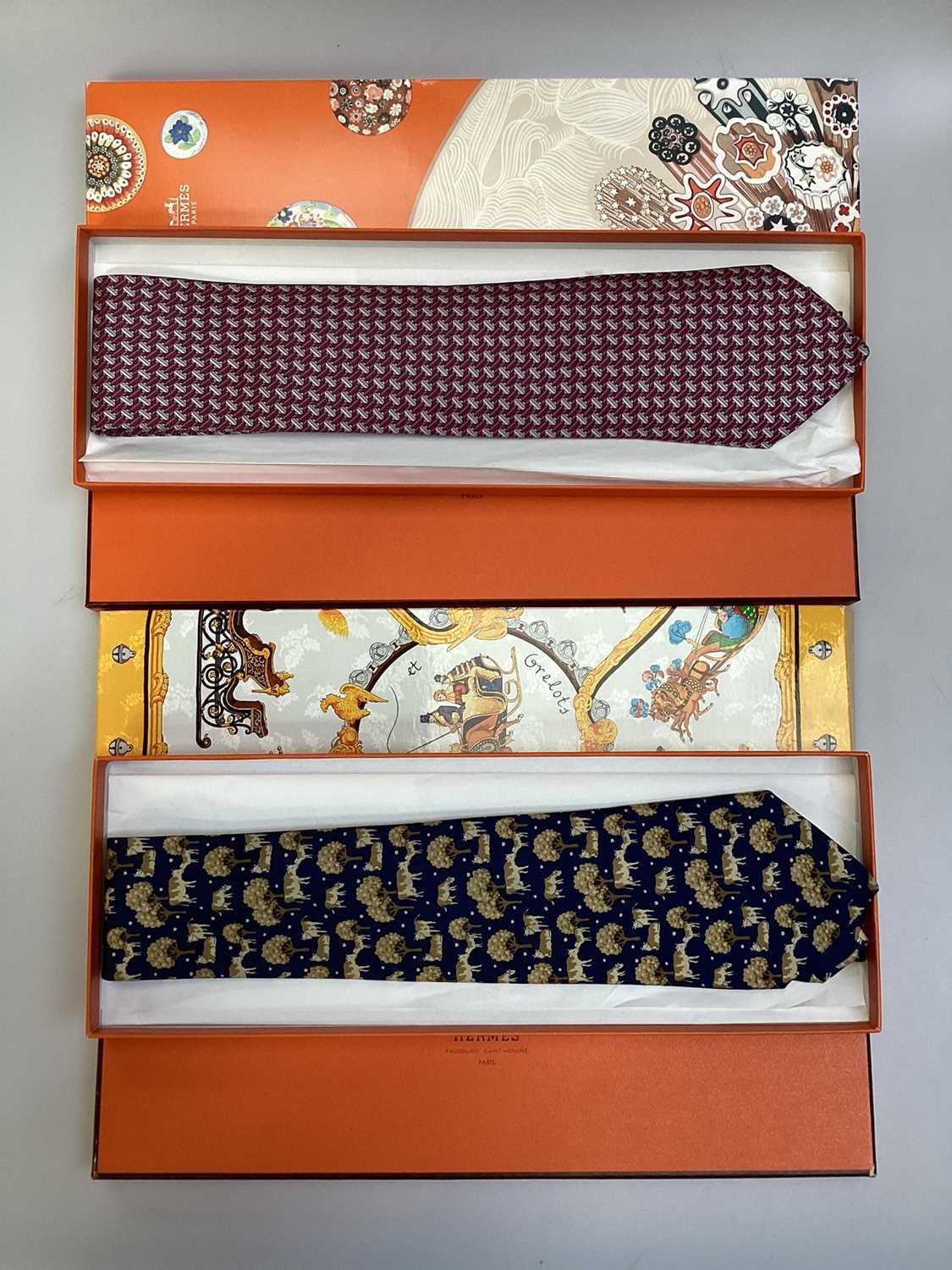 Lot 2083 - Four Hermès silk ties, cows and trees 7527 1A, geometric 5080 PA, navy horse bit 7297 EA and pink and blue Pegasus 5117 HA, all in Hermes tie boxes with tissue paper, two also in Hermes Christmas...