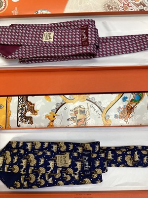 Lot 2083 - Four Hermès silk ties, cows and trees 7527 1A, geometric 5080 PA, navy horse bit 7297 EA and pink and blue Pegasus 5117 HA, all in Hermes tie boxes with tissue paper, two also in Hermes Christmas...