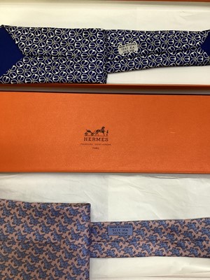 Lot 2083 - Four Hermès silk ties, cows and trees 7527 1A, geometric 5080 PA, navy horse bit 7297 EA and pink and blue Pegasus 5117 HA, all in Hermes tie boxes with tissue paper, two also in Hermes Christmas...