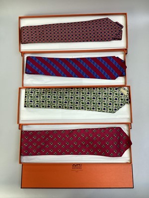Lot 2084 - Four Hermès silk ties, Jockey riding ostrich 7987 EA, apples 7691 OA, linked horsebit 7248 MA and stylised tulip 7271 MA all in Hermes tie boxes with tissue paper.