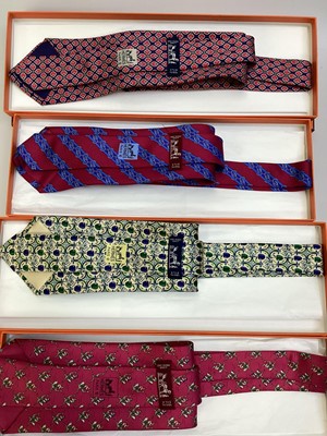 Lot 2084 - Four Hermès silk ties, Jockey riding ostrich 7987 EA, apples 7691 OA, linked horsebit 7248 MA and stylised tulip 7271 MA all in Hermes tie boxes with tissue paper.