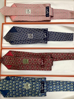 Lot 2086 - Four Hermès silk ties, leaves 7752 OA, geometric 7662 TA, penguins 5143 HA and interlinked cirles 7346 PAall in Hermes tie boxes with tissue paper