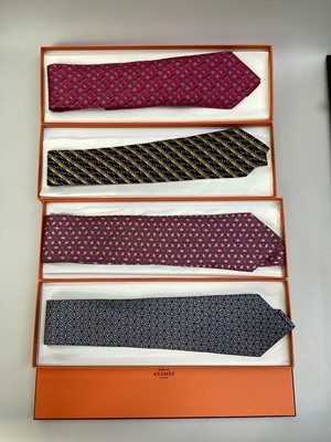 Lot 2087 - Four Hermès silk ties, floral geometric 5082 PA, horse bit with stripes 7223UA, inital H with buttons 7975 EA and interlinked circles 7633 TA, all in Hermes tie boxes with tissue paper