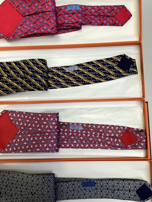 Lot 2087 - Four Hermès silk ties, floral geometric 5082 PA, horse bit with stripes 7223UA, inital H with buttons 7975 EA and interlinked circles 7633 TA, all in Hermes tie boxes with tissue paper