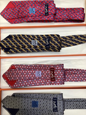 Lot 2087 - Four Hermès silk ties, floral geometric 5082 PA, horse bit with stripes 7223UA, inital H with buttons 7975 EA and interlinked circles 7633 TA, all in Hermes tie boxes with tissue paper