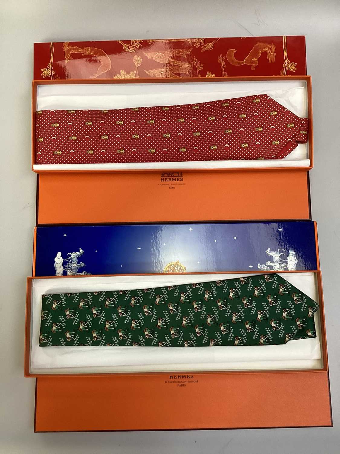Lot 2088 - Four Hermès silk ties, rice paddy fields 7535 IA, Owl and Moon 7997 EA, ships wheel 7317 EA and stylised flowers 5010 EA, all in Hermes tie boxes with tissue paper, two also in Hermes Christmas...