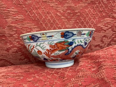 Lot 262 - A pair of Chinese porcelain bowls, Daoguang mark and period, decorated with a dragon and phoenix pattern in the Wucai style, 14.75cm diameter Provenance: brought home by Sir Francis Drum...