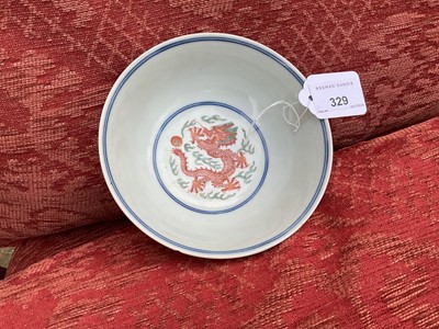 Lot 262 - A pair of Chinese porcelain bowls, Daoguang mark and period, decorated with a dragon and phoenix pattern in the Wucai style, 14.75cm diameter Provenance: brought home by Sir Francis Drum...