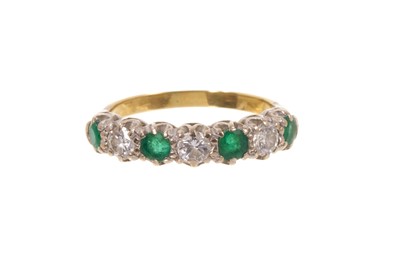 Lot 642 - Emerald and diamond seven stone ring in gold setting