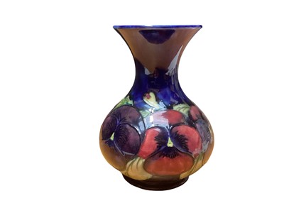 Lot 1140 - Moorcroft pottery vase decorated in the Pansy pattern, impressed marks and painted signature to base, 15.5cm high