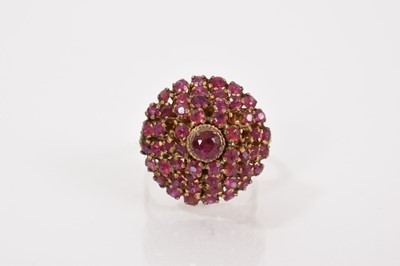 Lot 705 - Eastern ruby cluster ring in a tiered claw setting on yellow metal shank