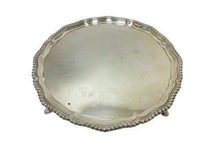 Lot 299 - Good quality George III style silver salver with gadrooned edge on pad feet, (London 1939)