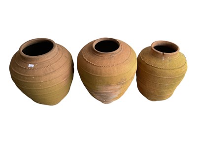 Lot 1552 - Three ribbed terracotta garden pots