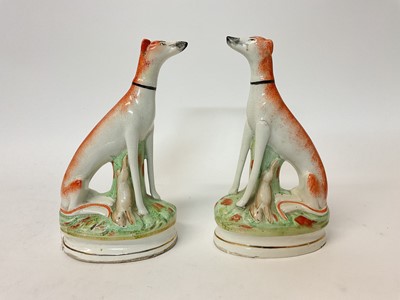 Lot 71 - Pair of Victorian-style Staffordshire pottery models of seated greyhounds, 23cm high