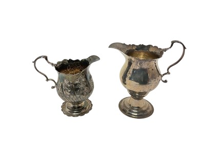 Lot 342 - George III silver cream jug of baluster form, with embossed floral decoration and one otherl
