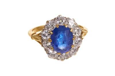 Lot 585 - Sapphire and diamond cluster ring