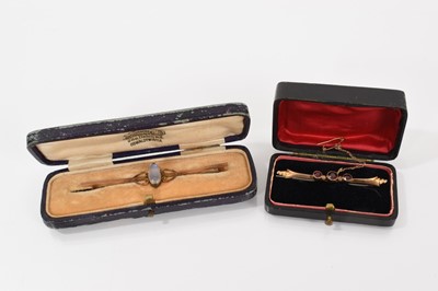 Lot 591 - Edwardian moonstone bar brooch and an Edwardian garnet brooch (2)