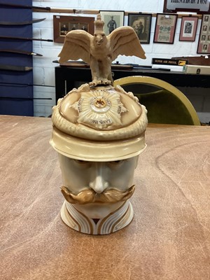 Lot 819 - Impressive Imperial German porcelain stein in the form of Kaiser Wilhelm II wearing a Garde du Corps helmet, the hinged cover with metal mount and ornate thumb piece with cross and laurel wreath...
