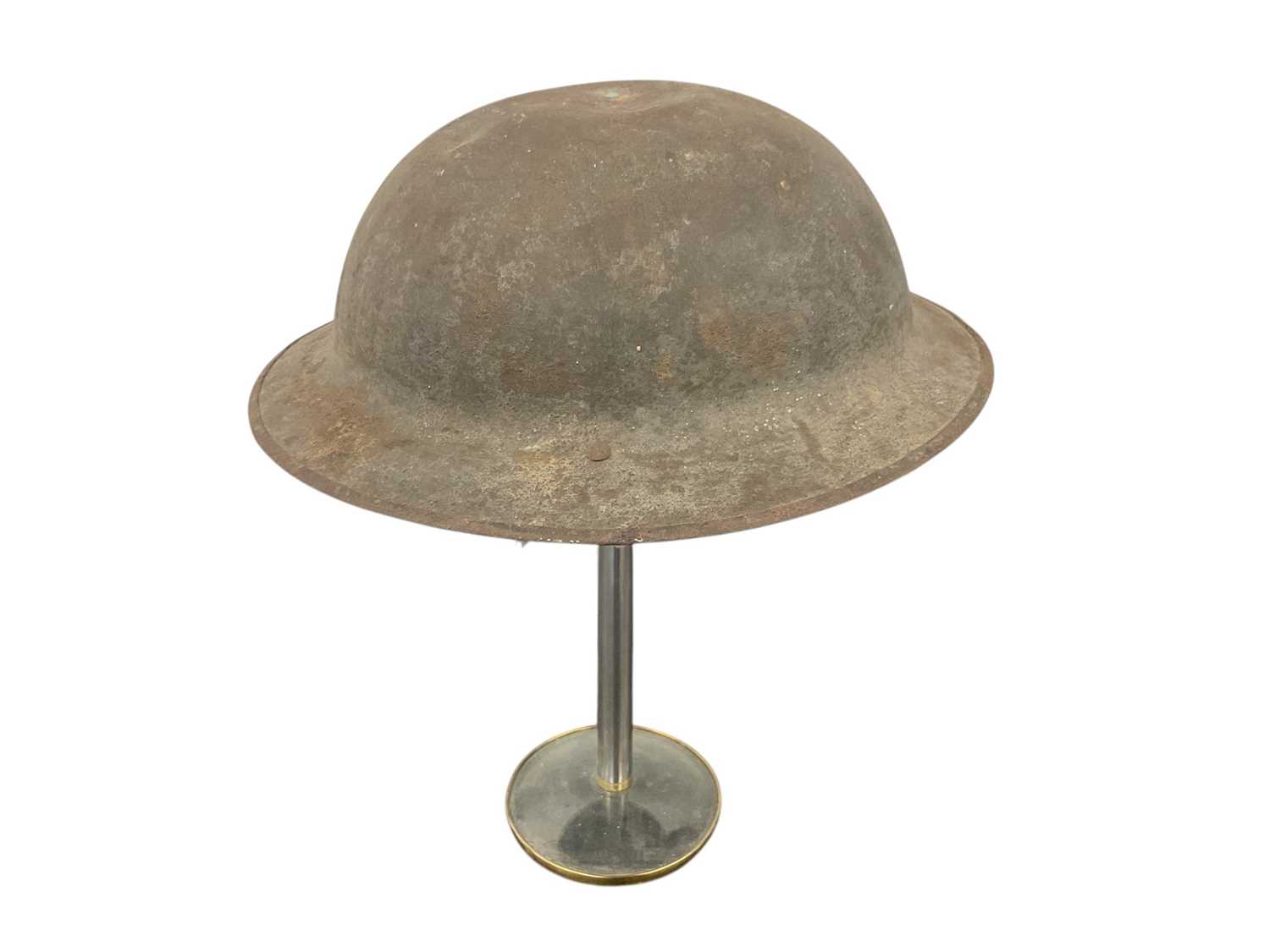 Lot 834 - First World War Mark 1 British Officers steel helmet with traces of square badges front and back, traces of liner and camouflage netting with leather chin strap, stamped numbers to rim