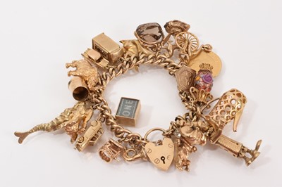 Lot 632 - Heavy 9ct gold charm with nineteen 9ct gold charms and a gilt half penny