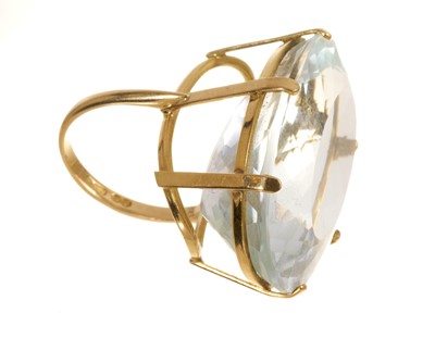Lot 639 - Large aquamarine dress ring with an oval mixed cut aquamarine in 18ct gold setting
