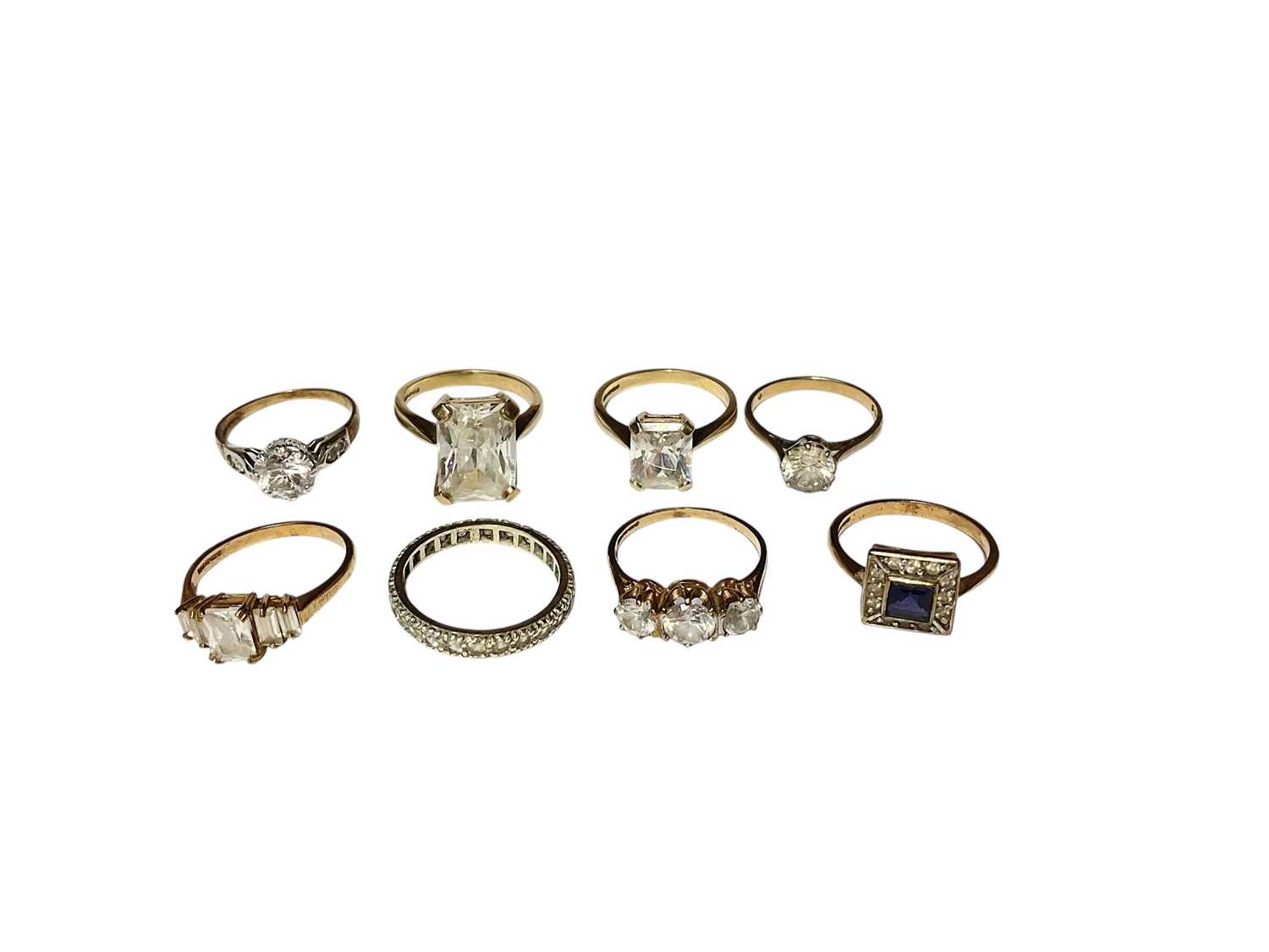 Lot 35 - Eight 9ct gold synthetic white stone dress rings