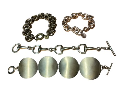 Lot 43 - Gilt metal horsebit bracelet, in the style of Gucci, Ermani Bulatti gilt metal bracelet, Italian Bronzallure oval link bracelet and a gilt disc bracelet (4)