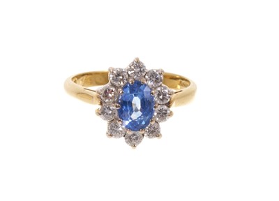 Lot 664 - Sapphire and diamond cluster ring with an oval mixed cut cornflower blue sapphire surrounded by a border of ten brilliant cut diamonds in 18ct gold setting