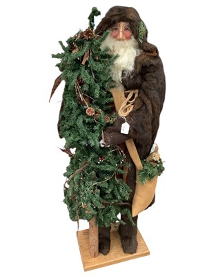 Lot 2790 - Large freestanding Father Christmas holding a Christmas Tree, 138cm in overall height.