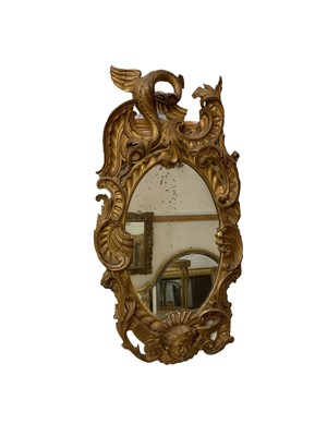 Lot 1561 - Ornate rococo style wall mirror with dragon and mask motifs