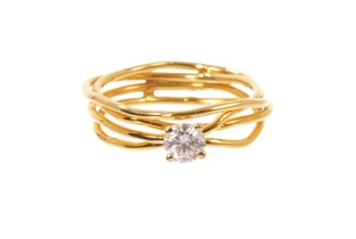 Lot 652 - Diamond ring with a brilliant cut diamond in four claw setting on a gold wire work shank