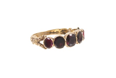 Lot 561 - Georgian garnet five stone ring with five oval mixed cut garnets in foil-backed gold collet setting on engraved scroll shank. Ring size K½