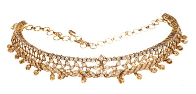 Lot 704 - Diamond set gold choker, the articulated band with foliate open work design suspending further diamond drops